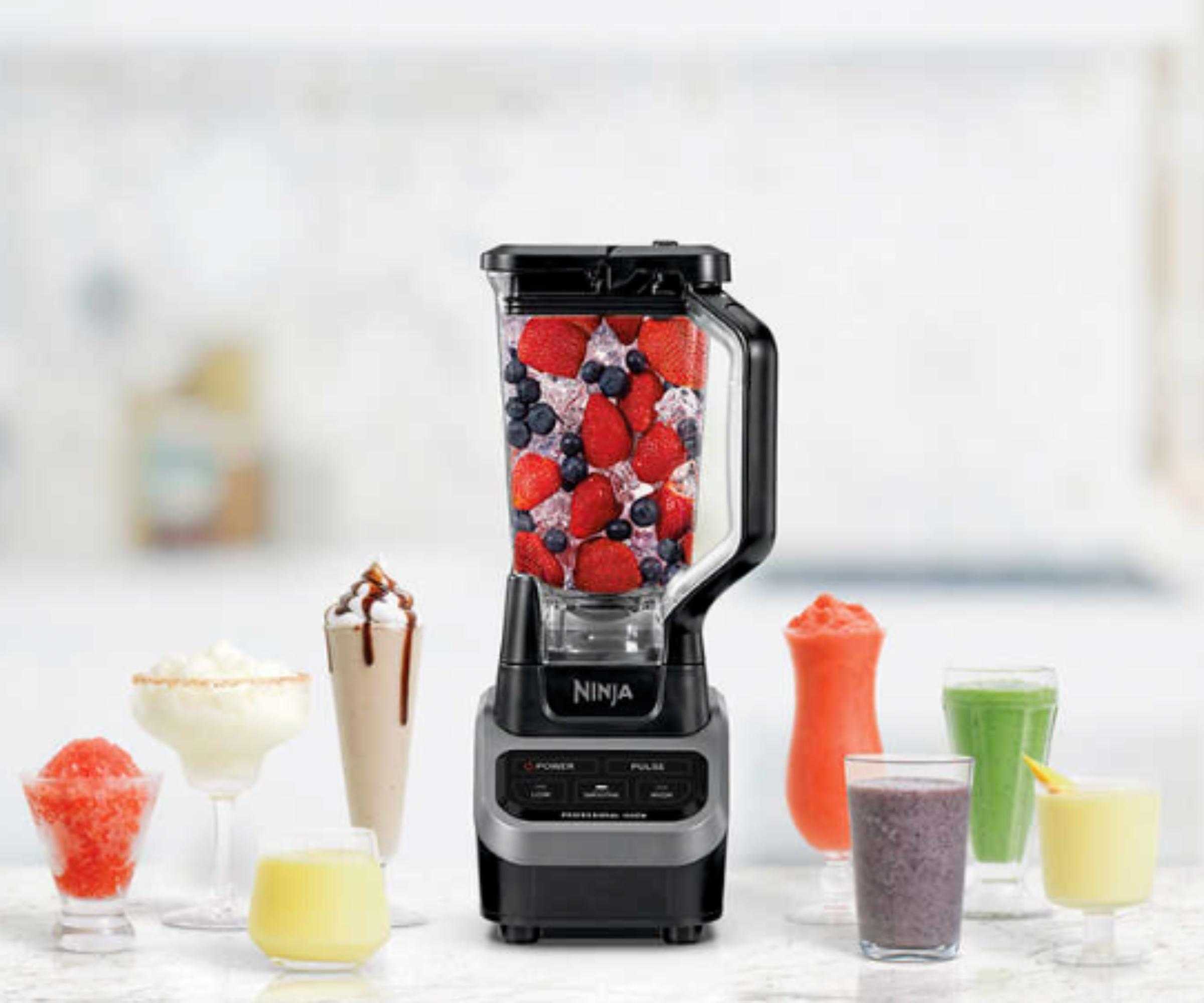 Ninja Foodi blender with auto IQ on a marble countertop surrounded by colorful drinks and coffees