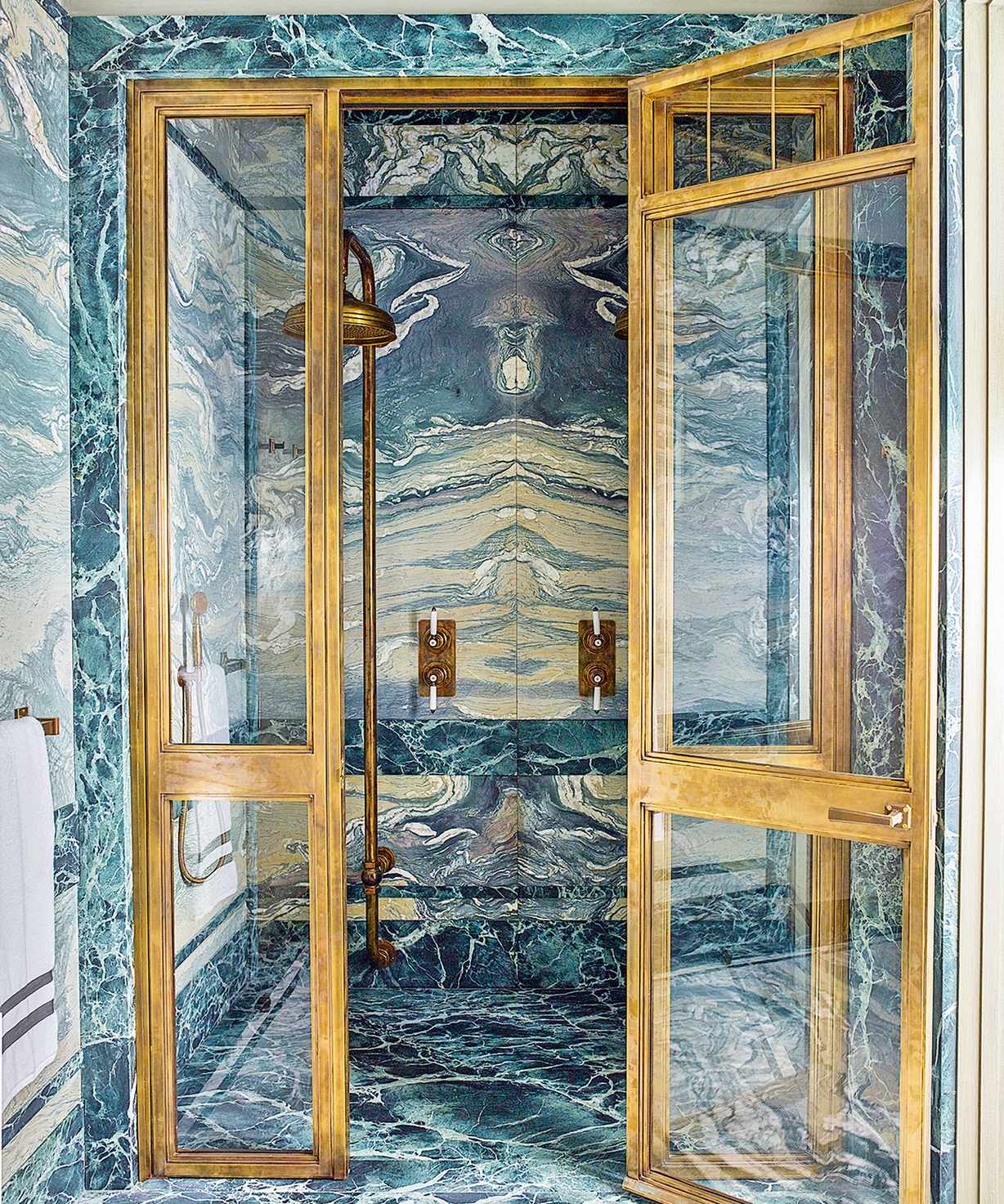 Green marble shower with gold accents