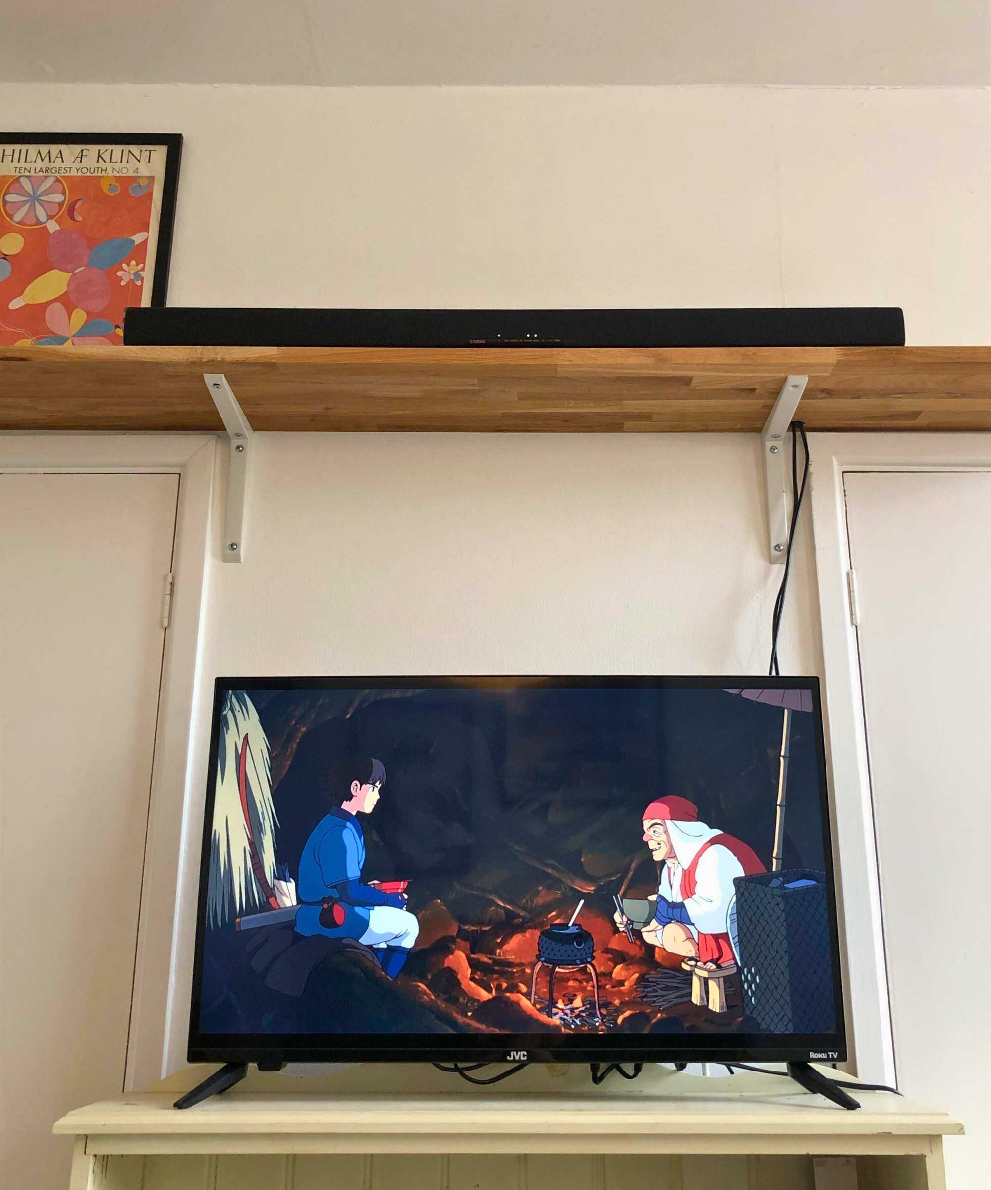 Yamaha True X Bar 40A soundbar on wooden shelf above TV playing Princess Mononoke in Dan Fauzi's home.