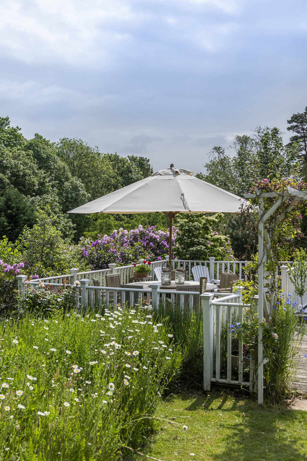 Outdoor dining area bordered by low fencing