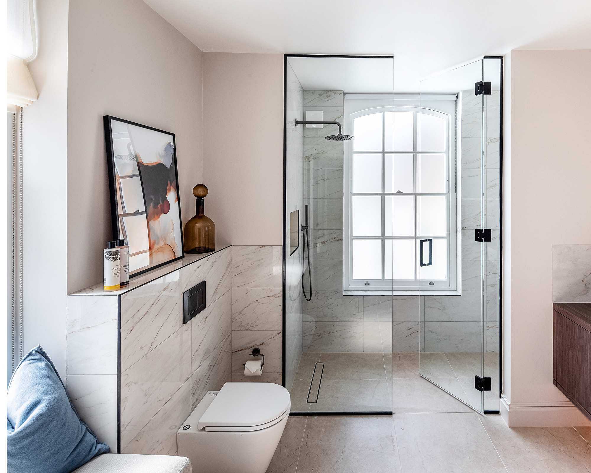 A master en-suite bathroom with walk-in shower and window seat