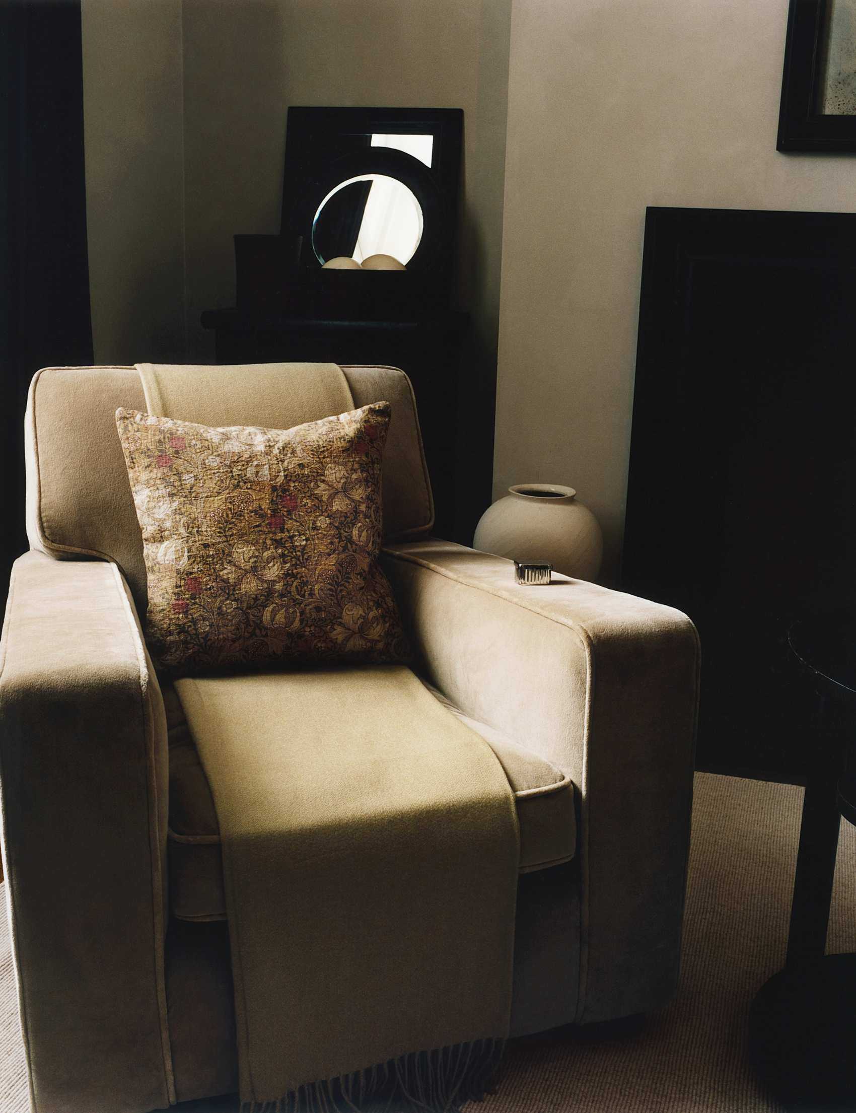 Neutral living room featuring a velvet armchair styled with a floral throw pillow cover from the newly debuted Zara Home x Morris &amp; Co. collection