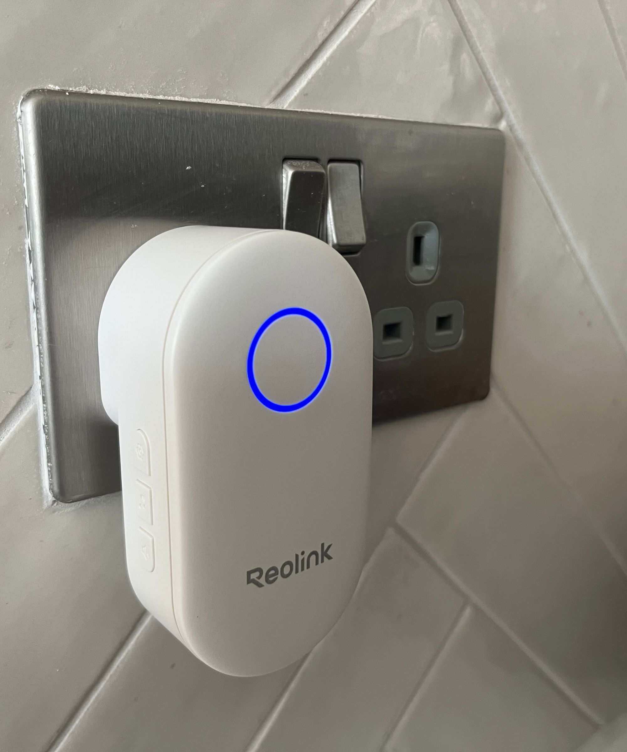 Reolink Chime plugged in to wall socket with blue light illuminated.