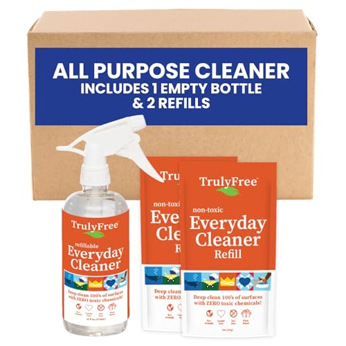 Two multi-purpose cleaning packets next to a matching spray bottle. In front of a cardboard box.