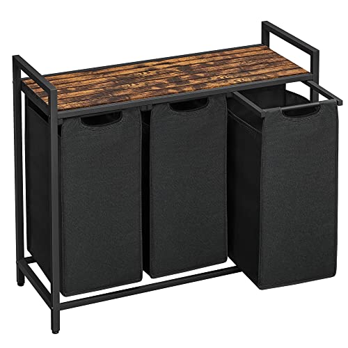A black shelving frame with a wooden shelf. Three black fabric laundry baskets hang beneath the shelf.