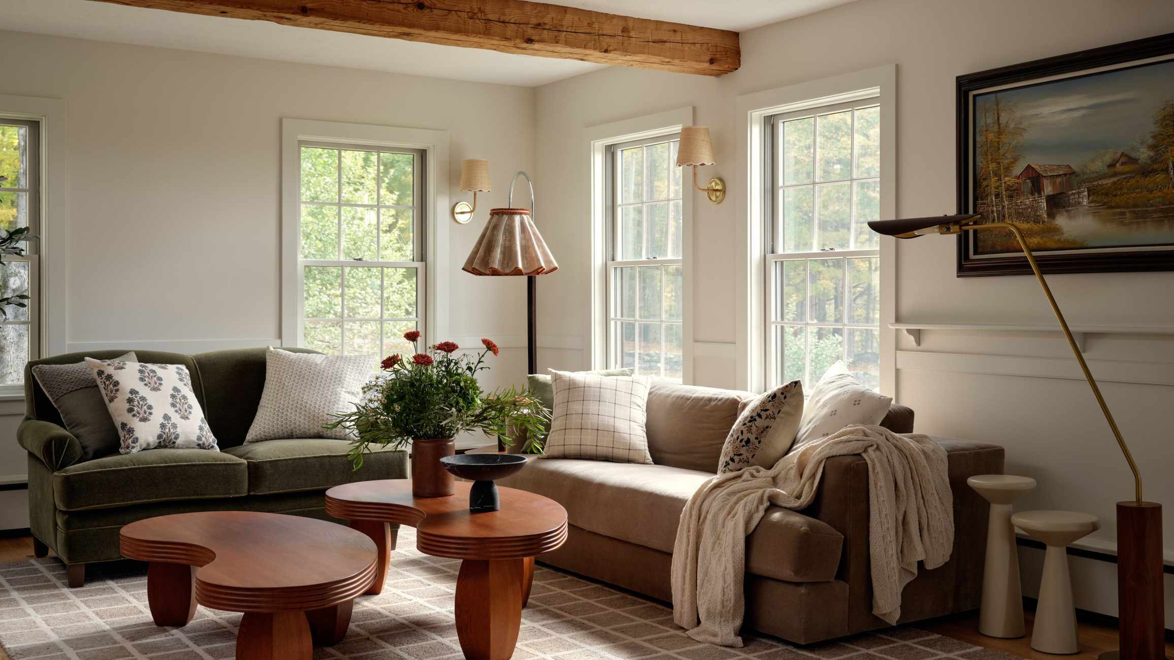 Neutral living room with ceiling. beams, an olive green sofa and a warm wood coffee table, interior