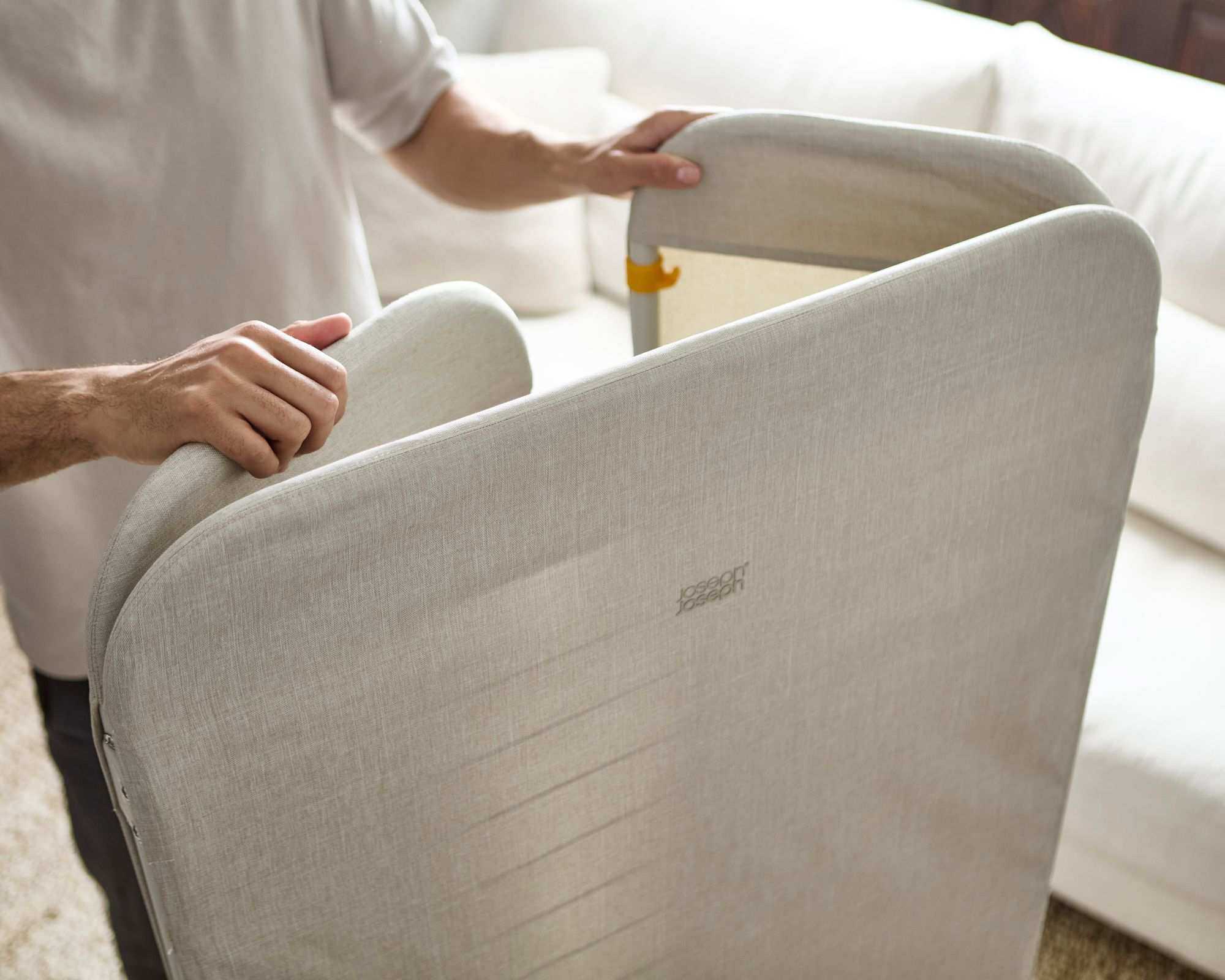 The Eclipse&trade; 3-tier Ecru Clothes Drying Rack With Screen being folded up