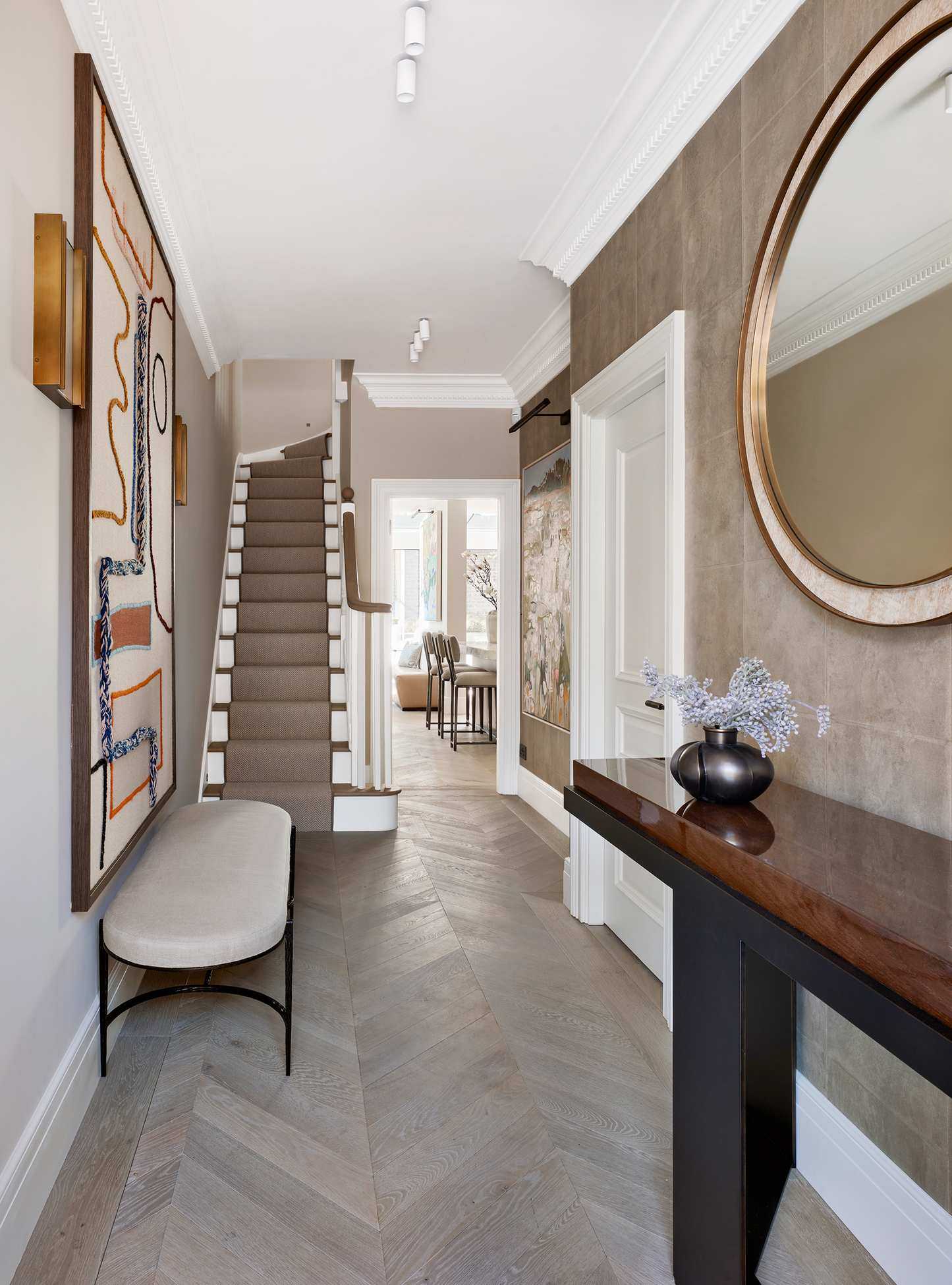 Neutral hall with gallery wall and wood floor