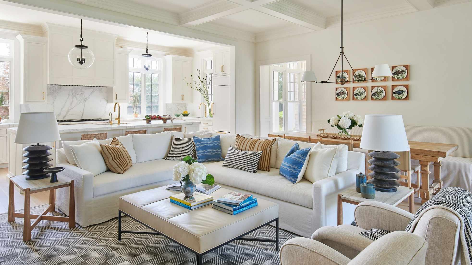 Open plan living kitchen dining and living area painted white with a large corner sofa
