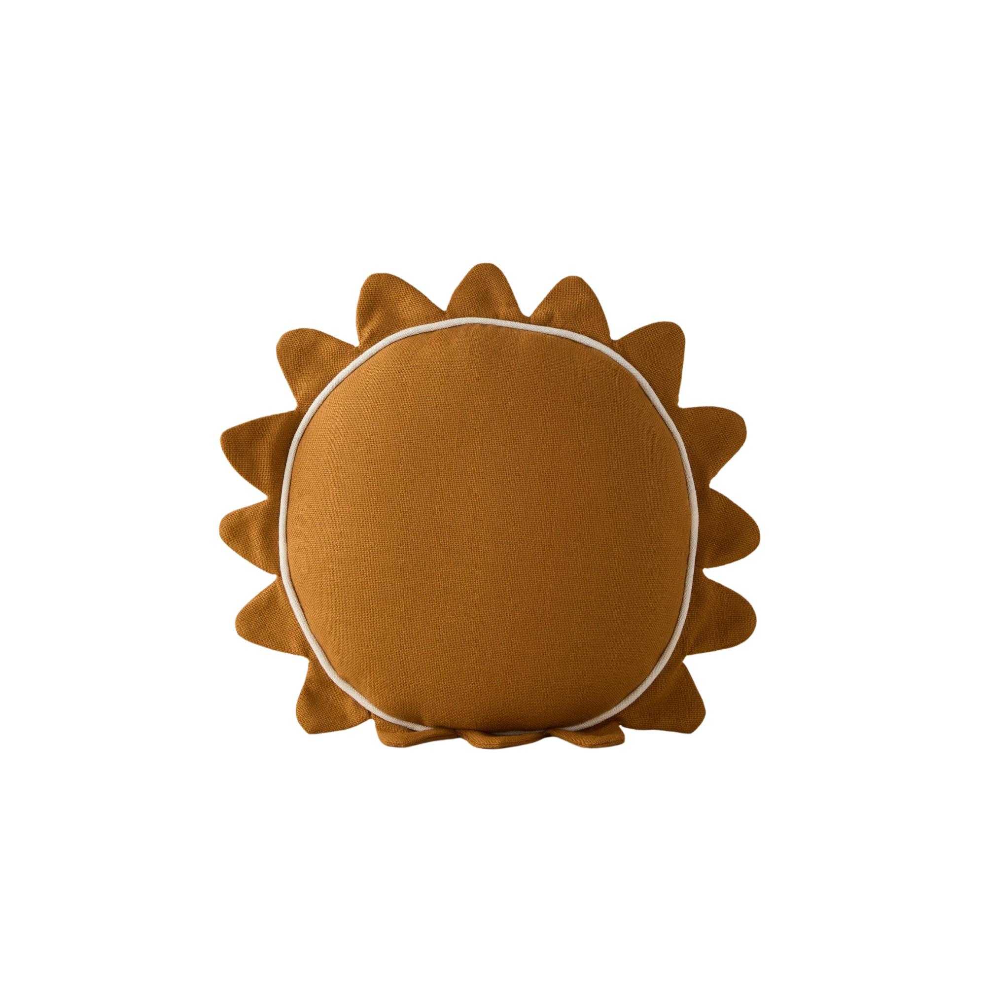 a yellow pillow in the shape of a sun