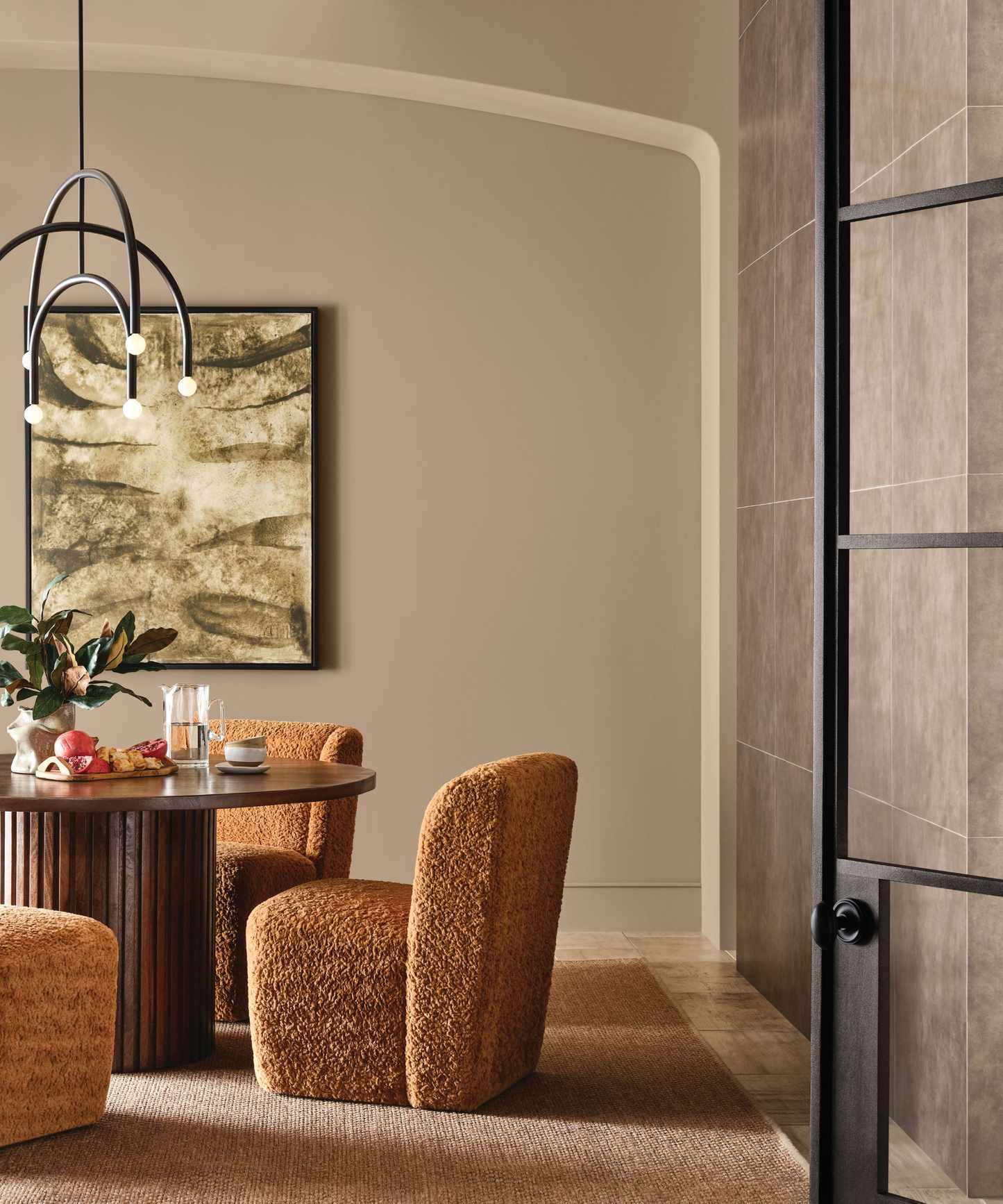 Dining room with neutral walls, crittall door, wood dining table, boucle chairs and pendant light