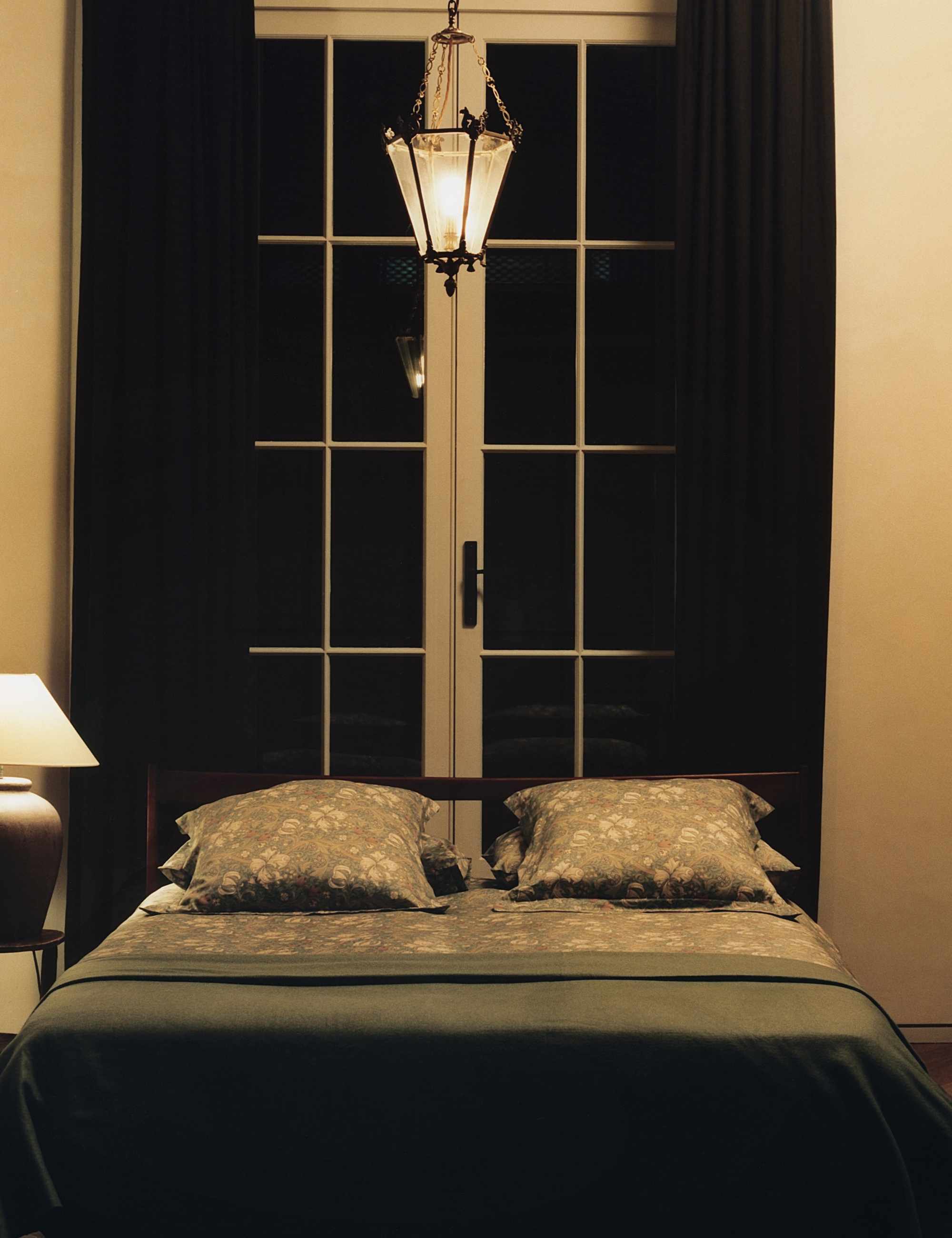 Modern London bedroom featuring a low-slung bed styled with muted floral sheets