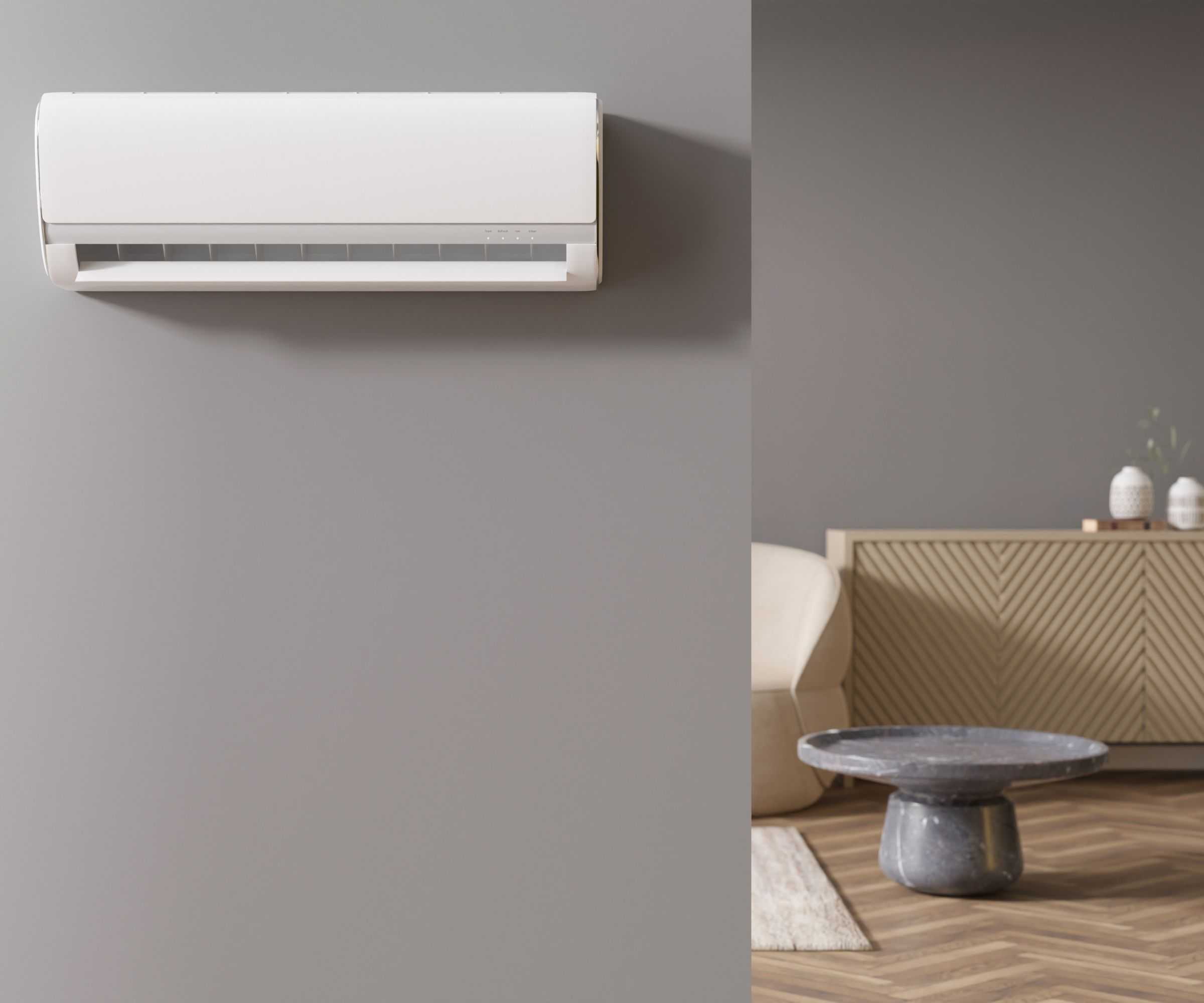 A white HVAC fen unit mounted to a grey painted wall. A living room visible through a doorway to the right hand side.
