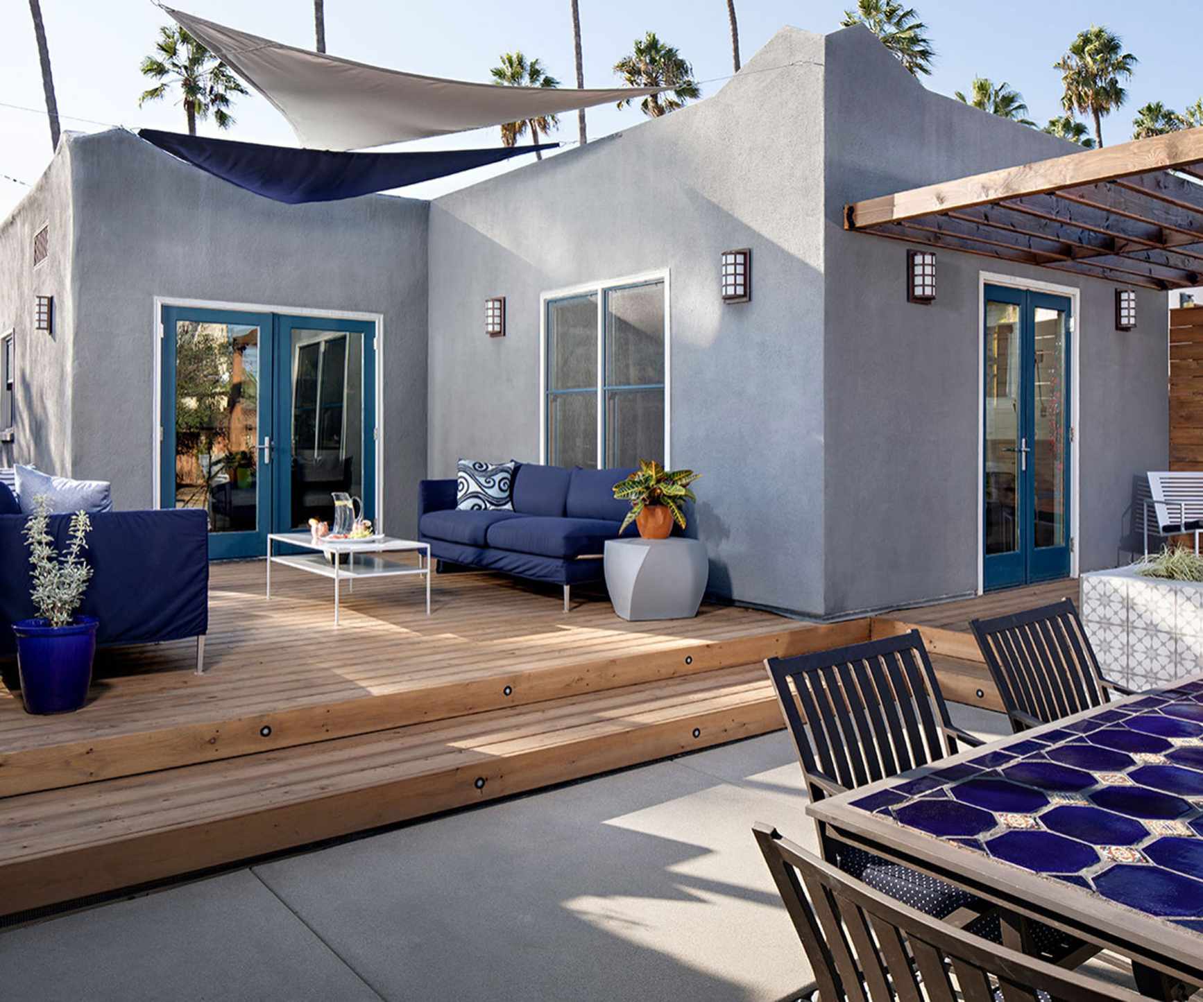split level deck and patio space with sail shade and pergola