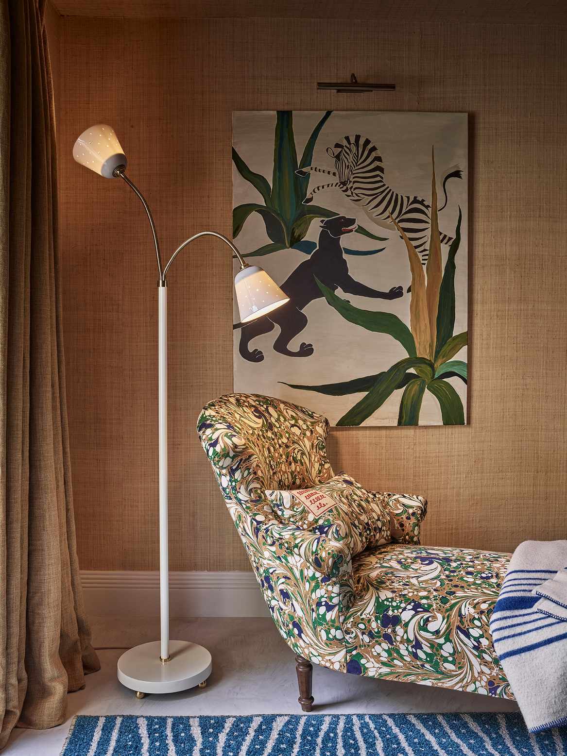 A living room with a chaise-long and a standing lamp