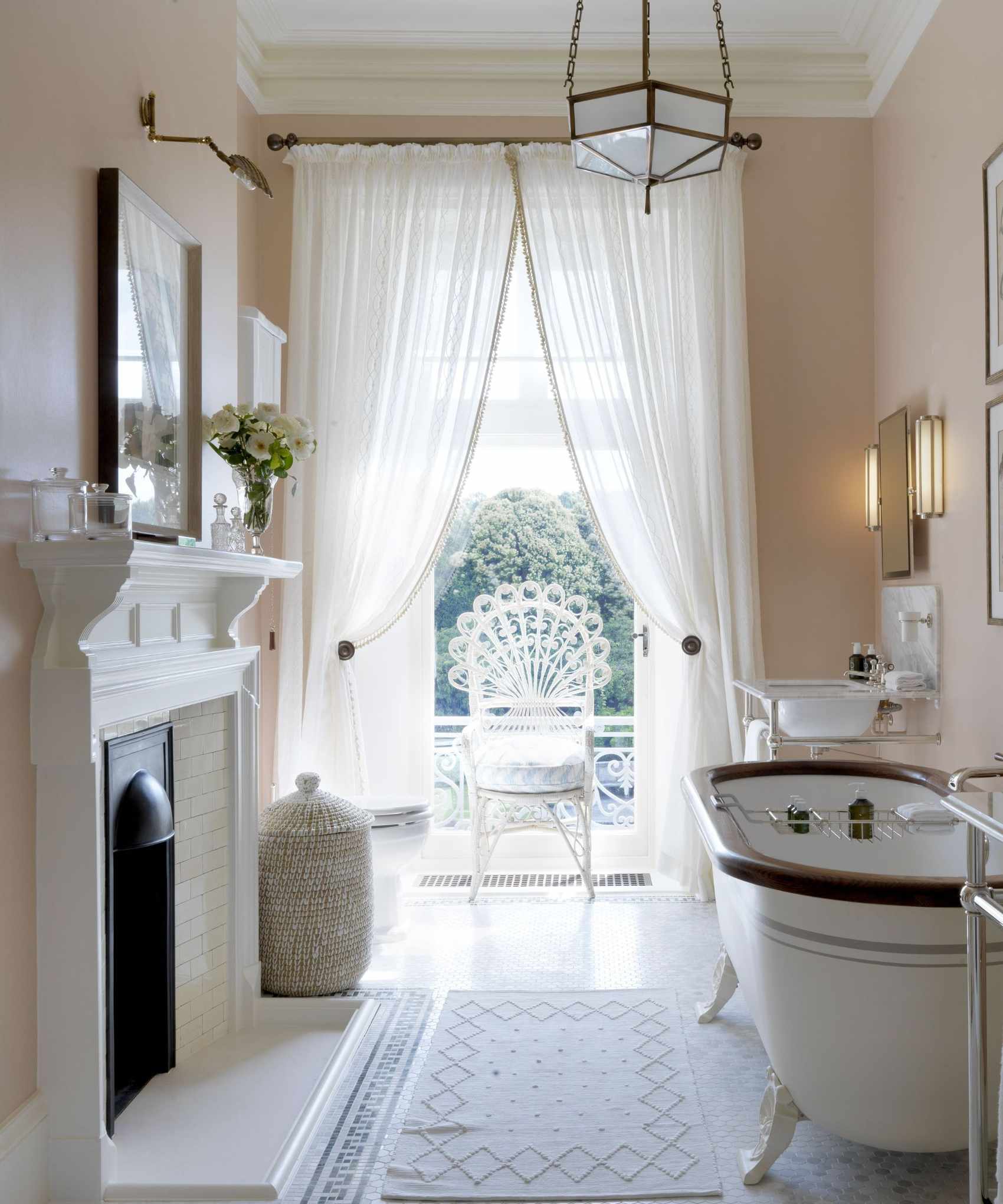 sheer window curtains in a vintage traditional bathroom with claw foot bathtub