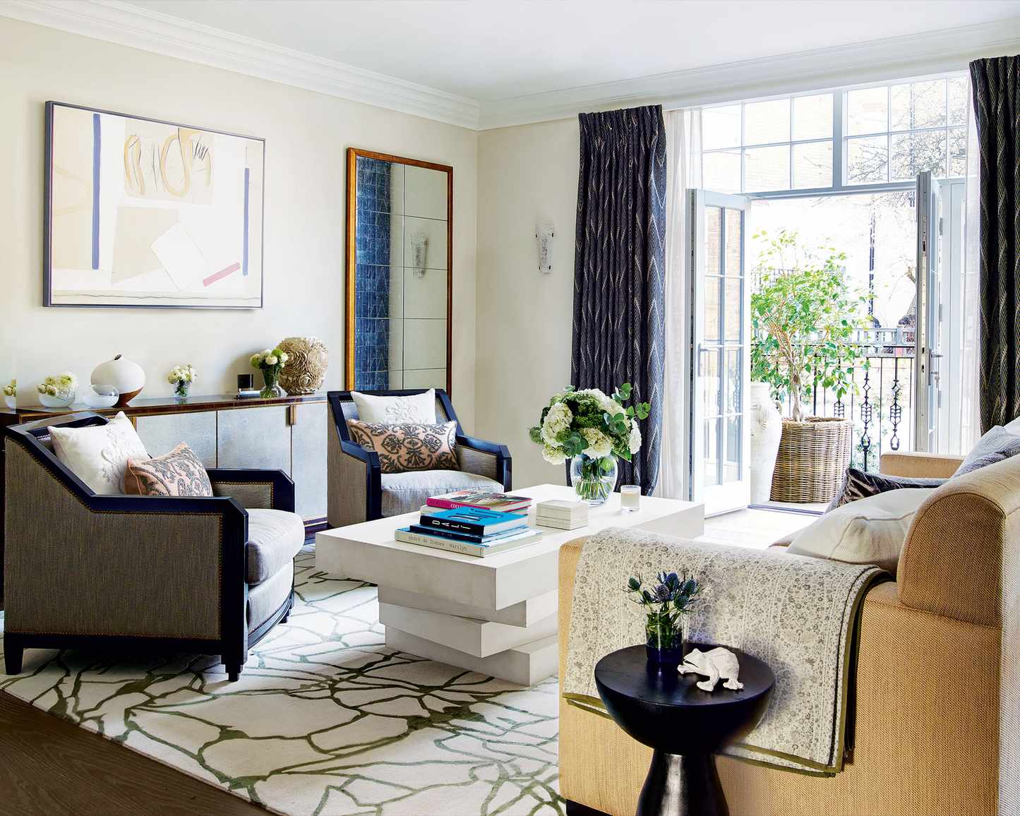 Beige living room ideas featuring traditional furniture, dark drapes and a patterned rug