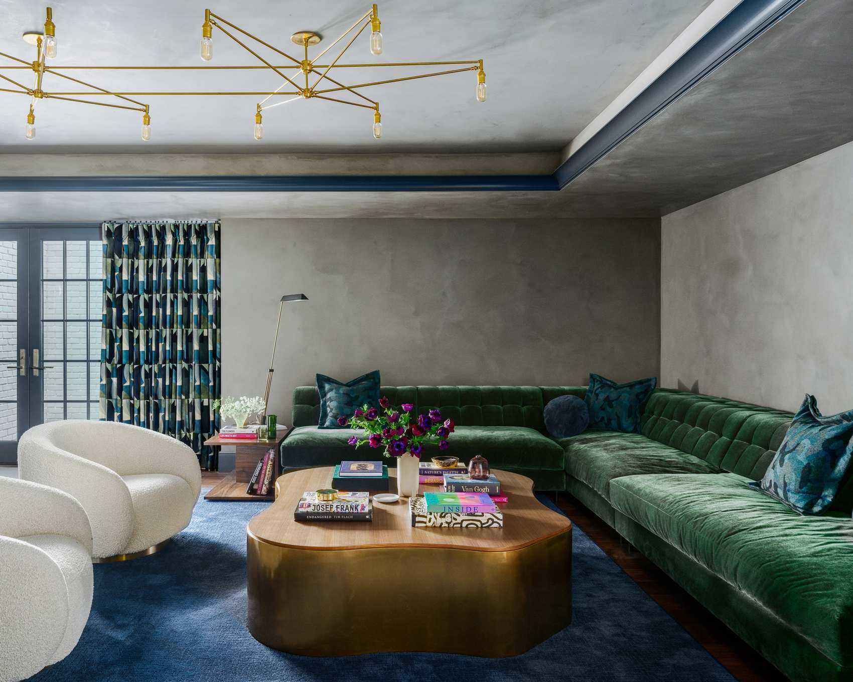 living room with green sofa and low furniture and large ceiling light