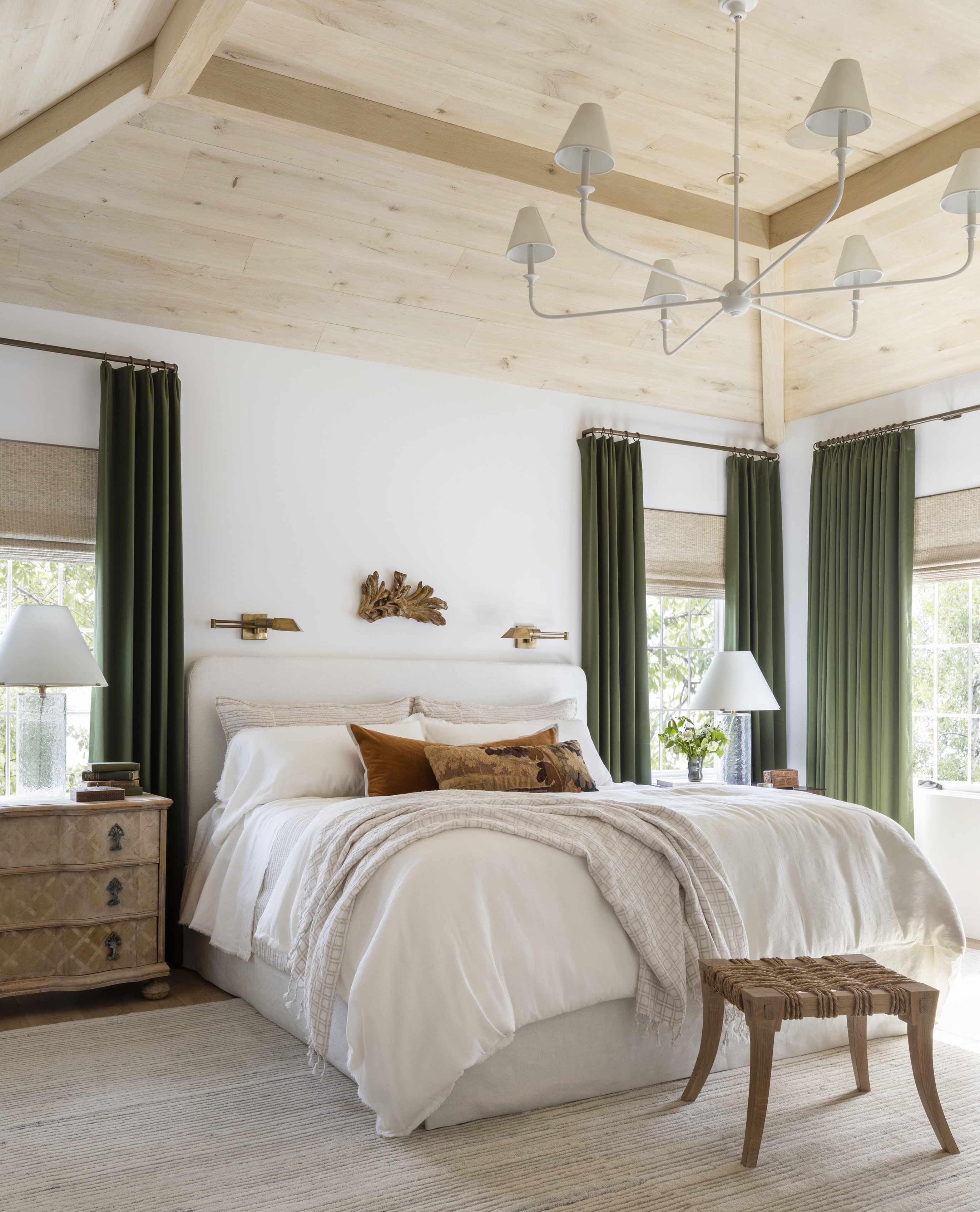 Luxury bedroom with neutral scheme and green velvet curtains