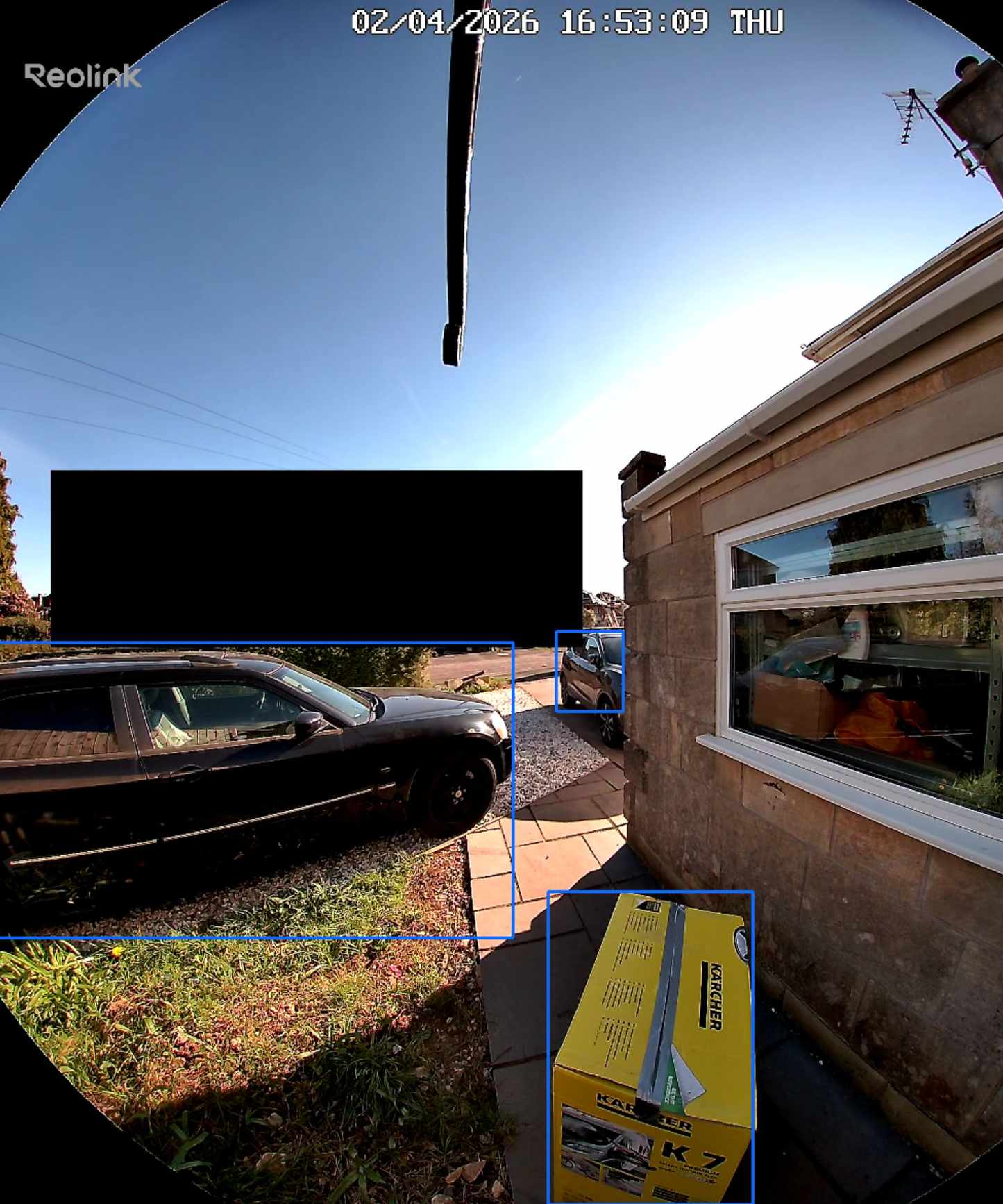 Screenshot of Reolink app, showing Reolink video doorbell (battery) detecting package and car on drive on sunny day.