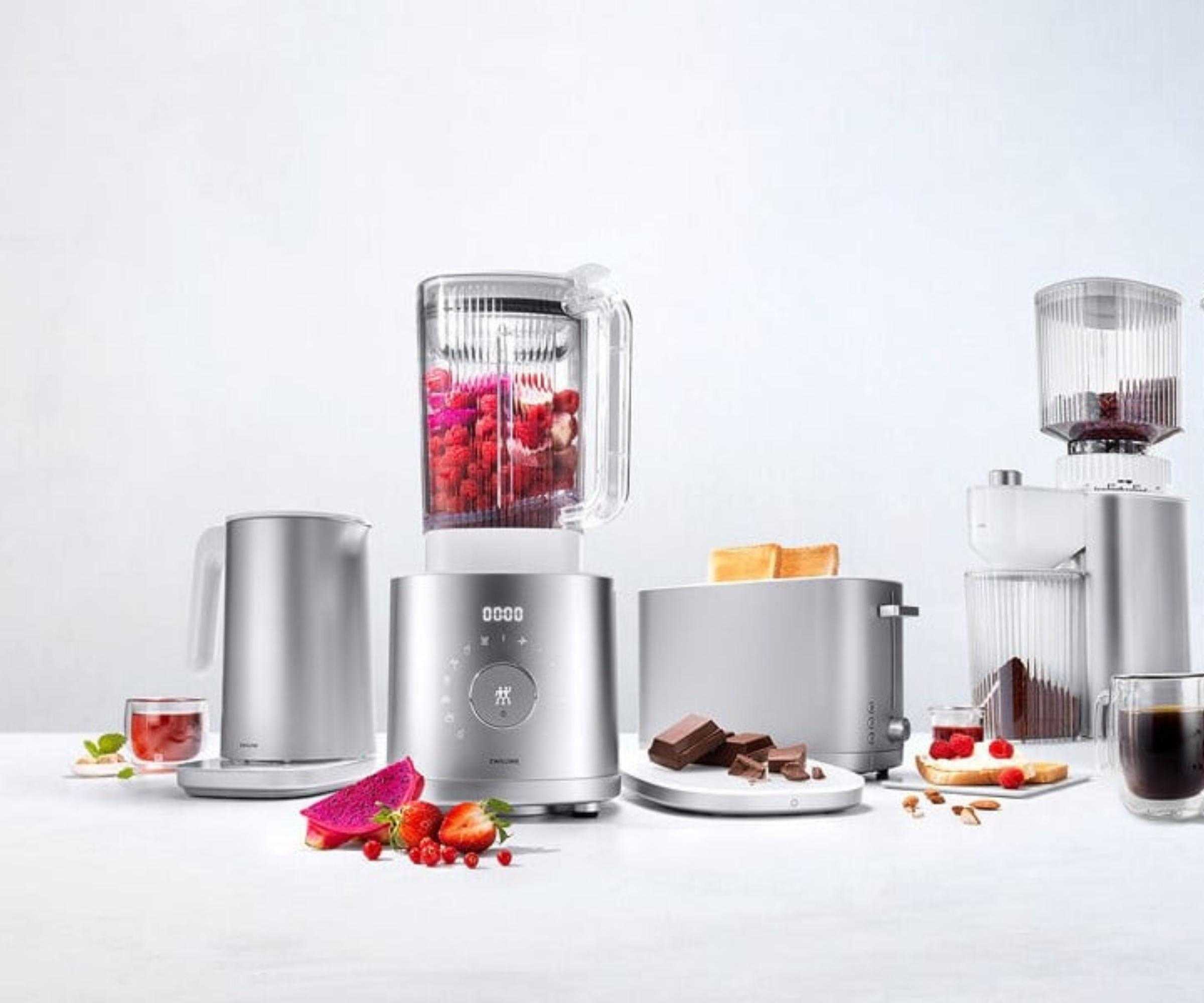 Zwilling Enfinigy range, including the Countertop Blender blending a berry smoothie