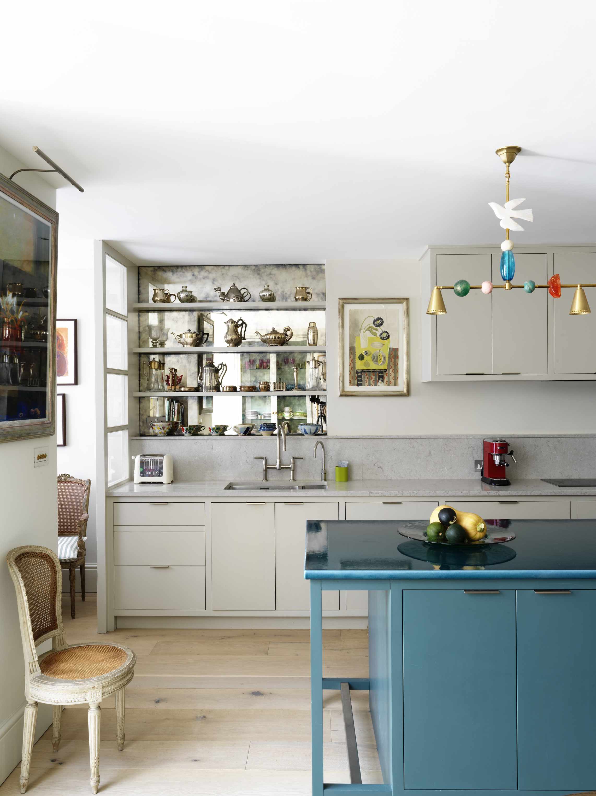 Kitchen with neutral cabinets and blue island