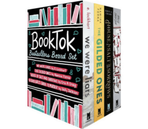 A box of books with the title "BookTok" on it is pictured. Inside the box are four books.