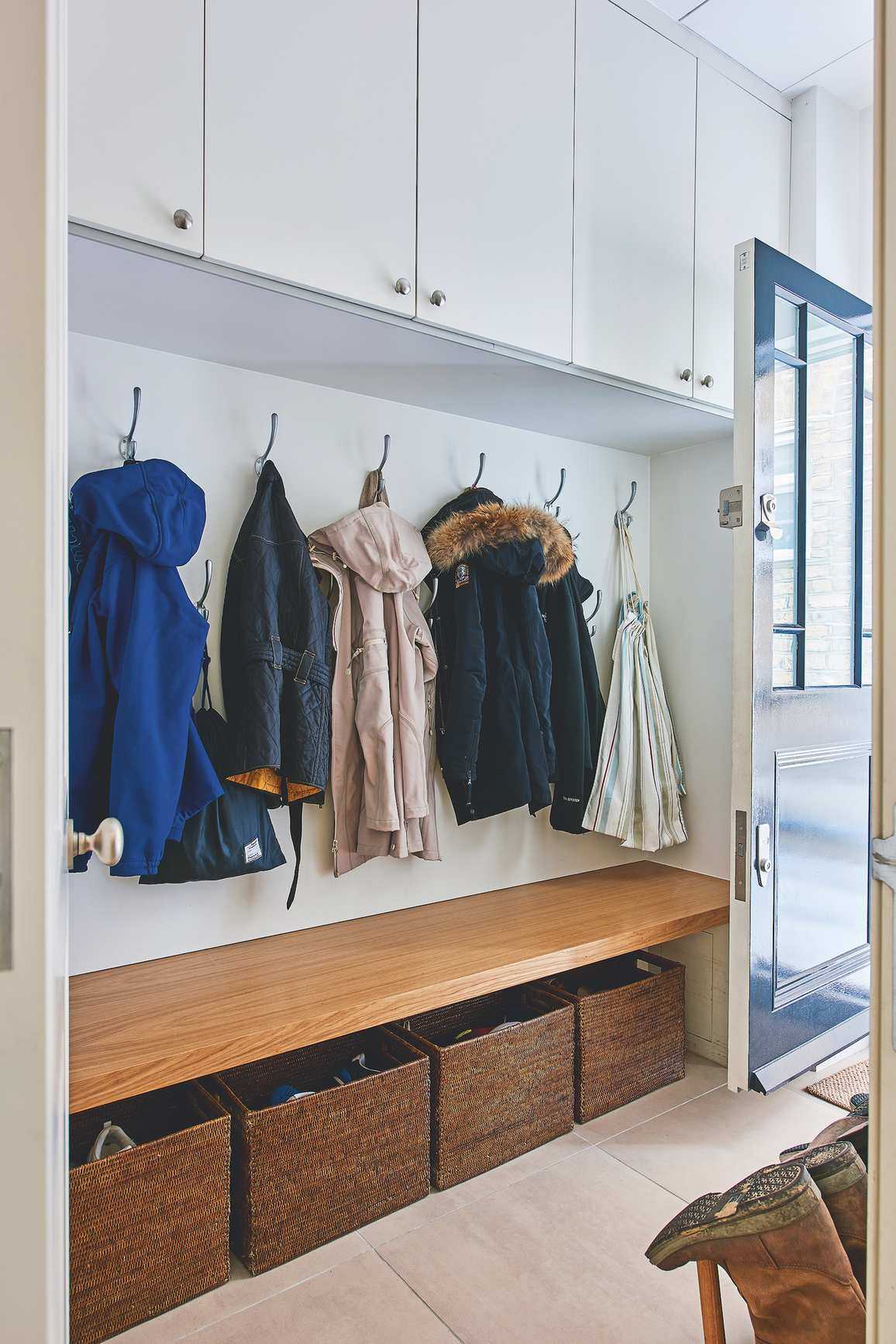 boot room with bench, hooks and overehead lockers