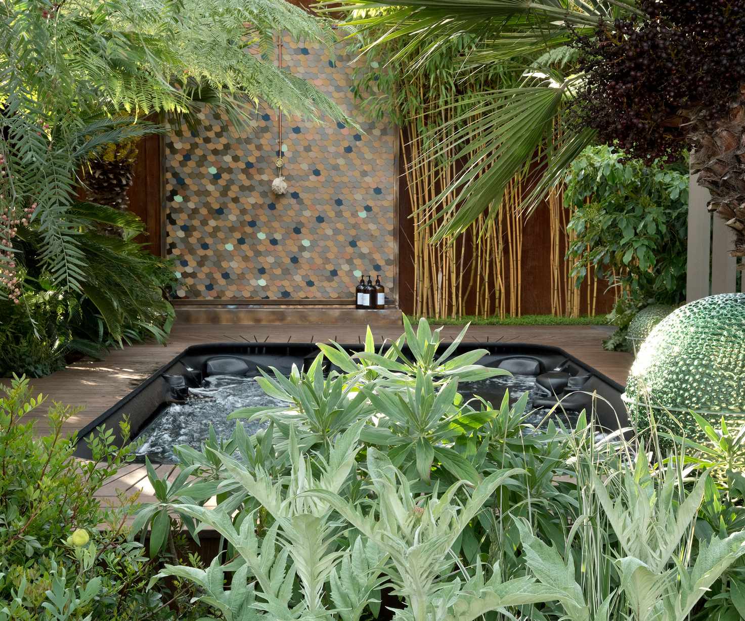 tropical-style backyard with outdoor pool, decking and outdoor shower