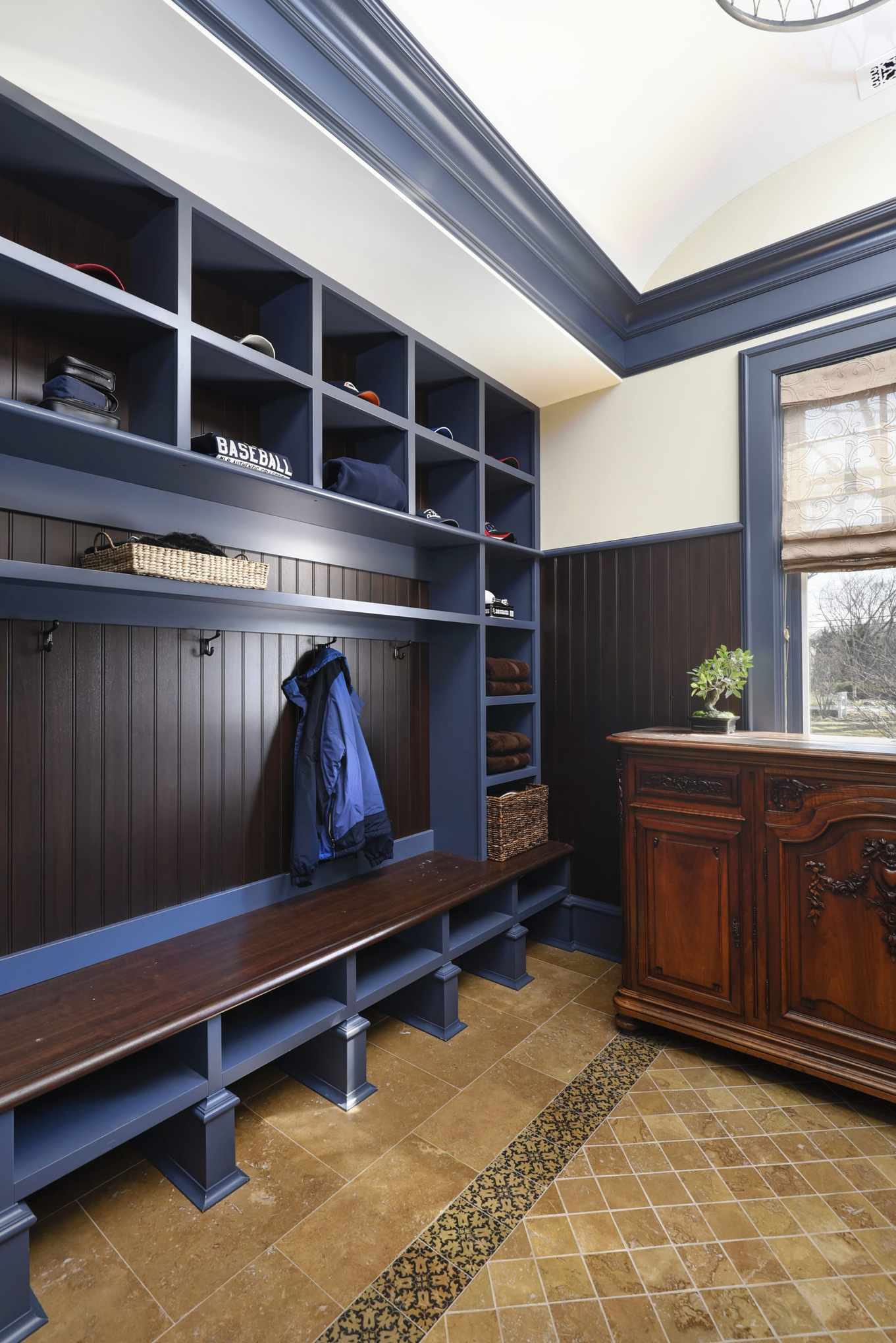 clubroom style mudroom with lockers and antique chest of drawers
