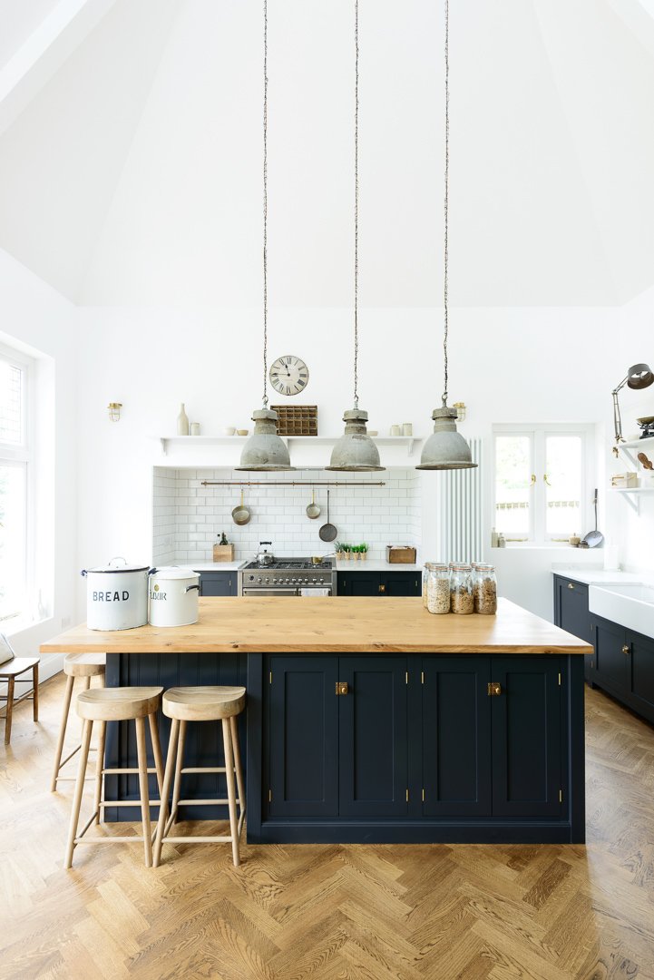 Kitchen with blue cabinets and island with wood countertop