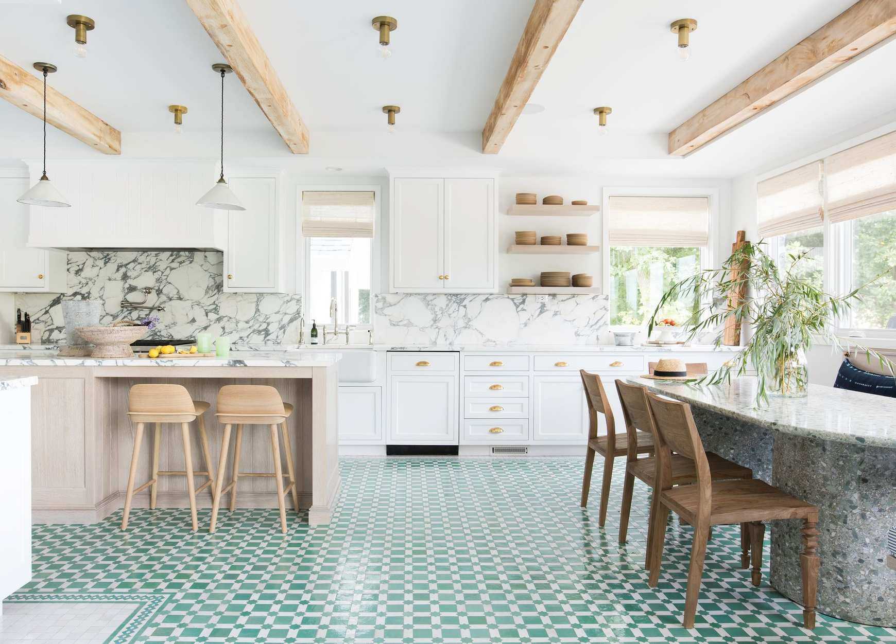 Kitchen with white cabinets and wood island