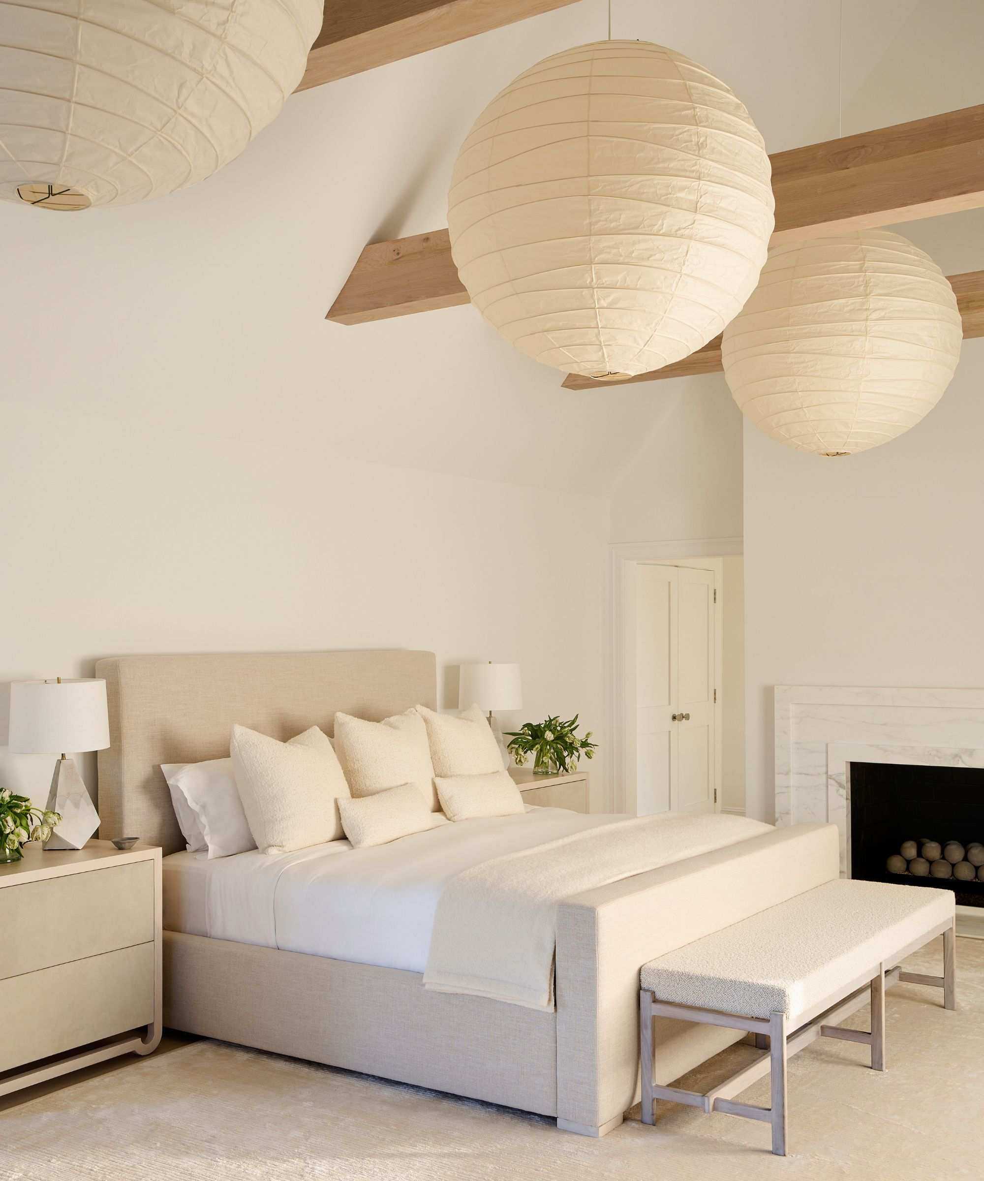 neutral coastal bedroom with large paper lanterns