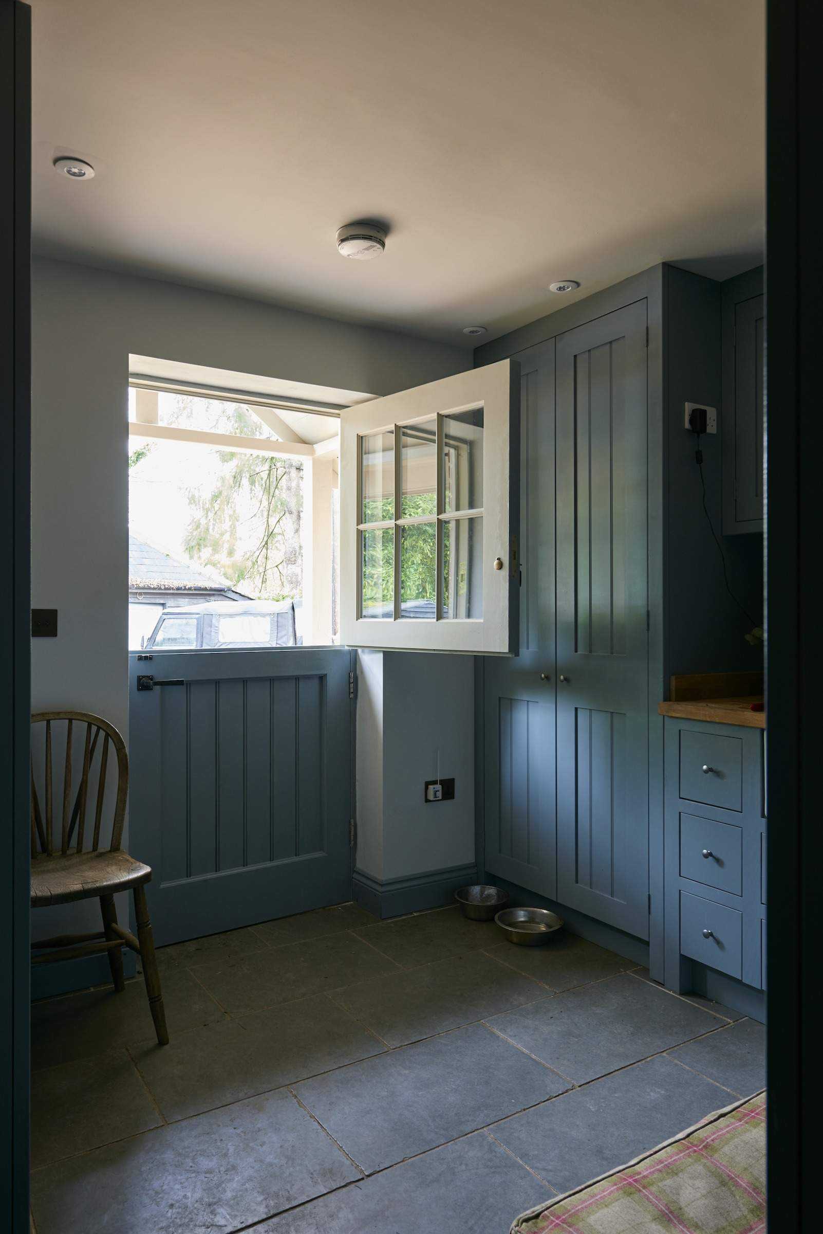 blue painted boot room with barn door