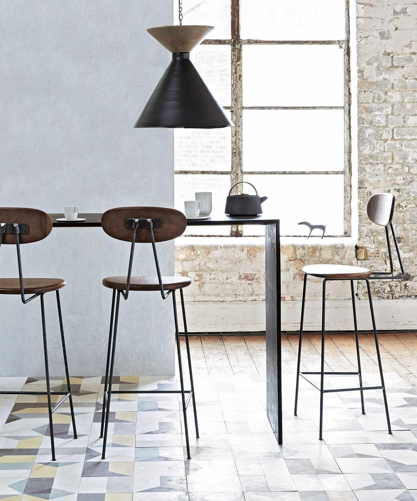 Small dining room with narrow table and bar stools