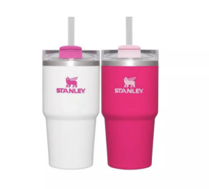 Two Stanley tumblers are pictured side by side. On the left is a white tumbler. On the right, the tumbler is pink.