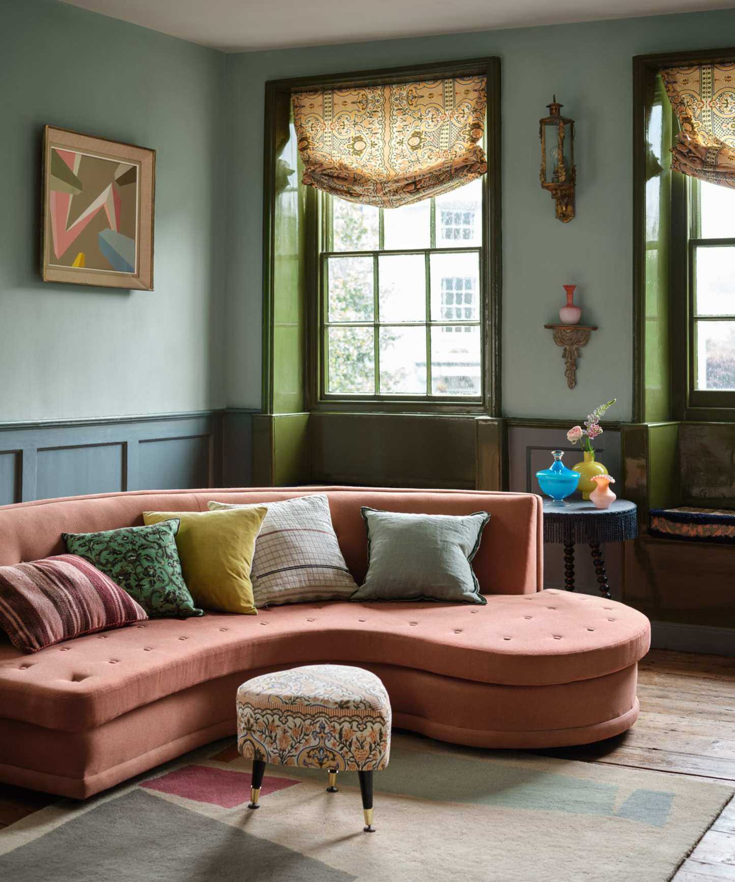 green and blue living room with pink sofa