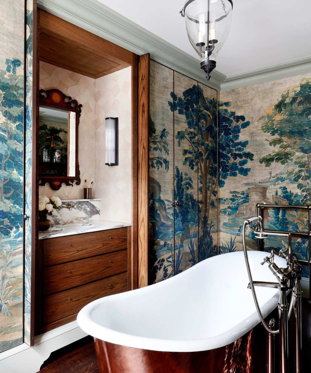 A broken plan bathroom with a freestanding bathtub and a vanity hidden behind pocket doors