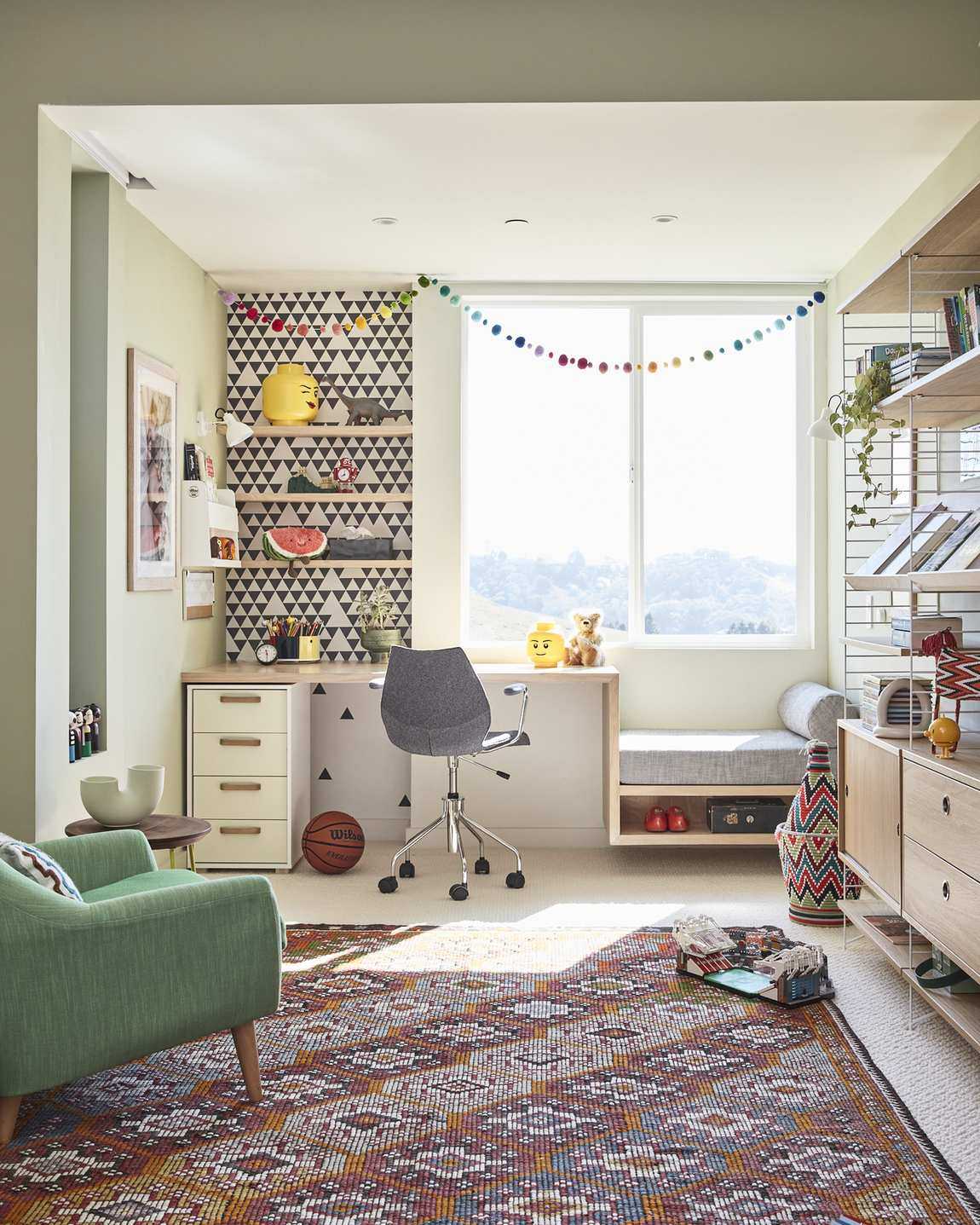 teen kids/bedroom ideas with wallpaper, desk, multicolored rug, green armchair, storage units