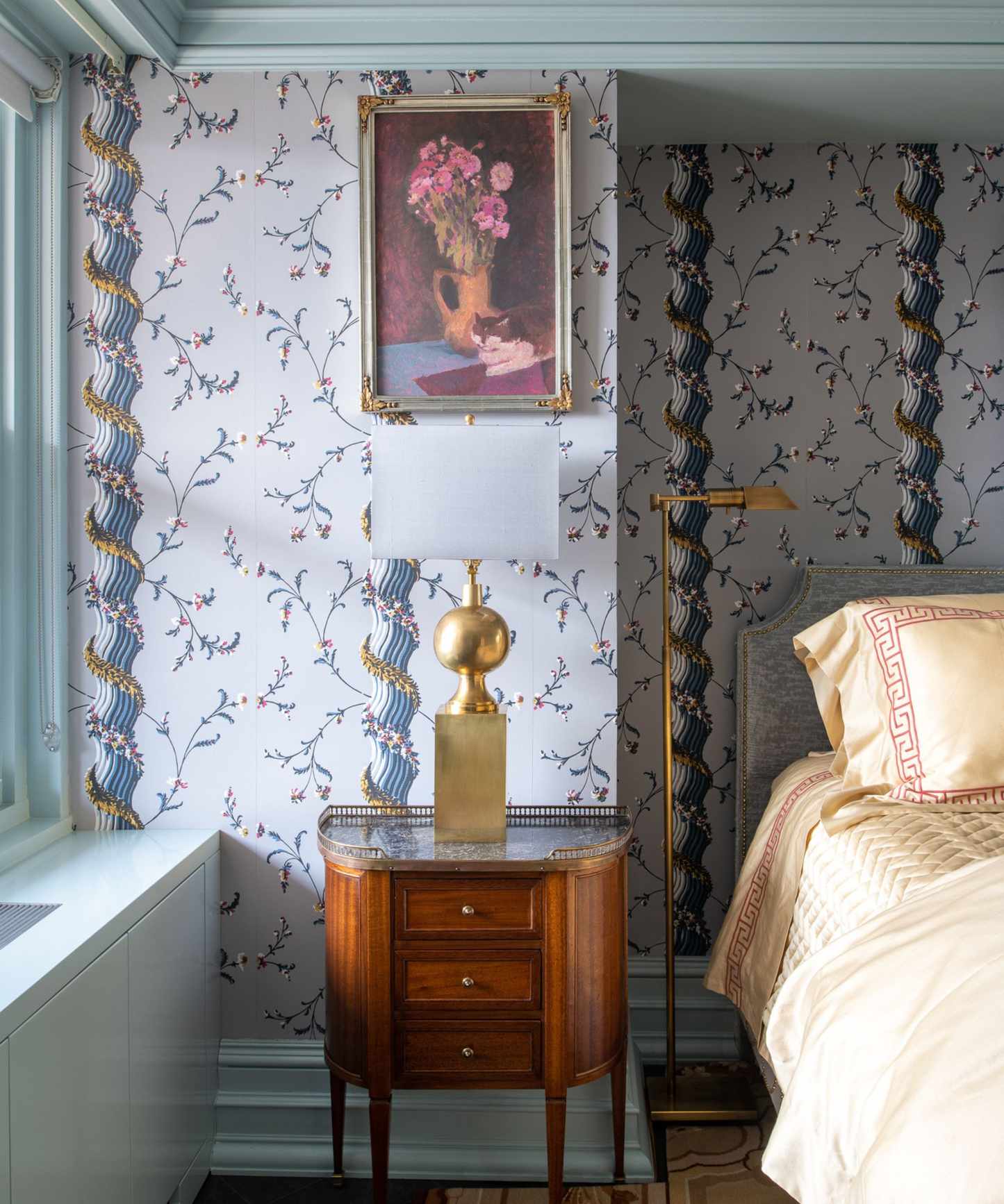 blue floral wallpapared bedroom with matching blue ceiling trim and woodwork