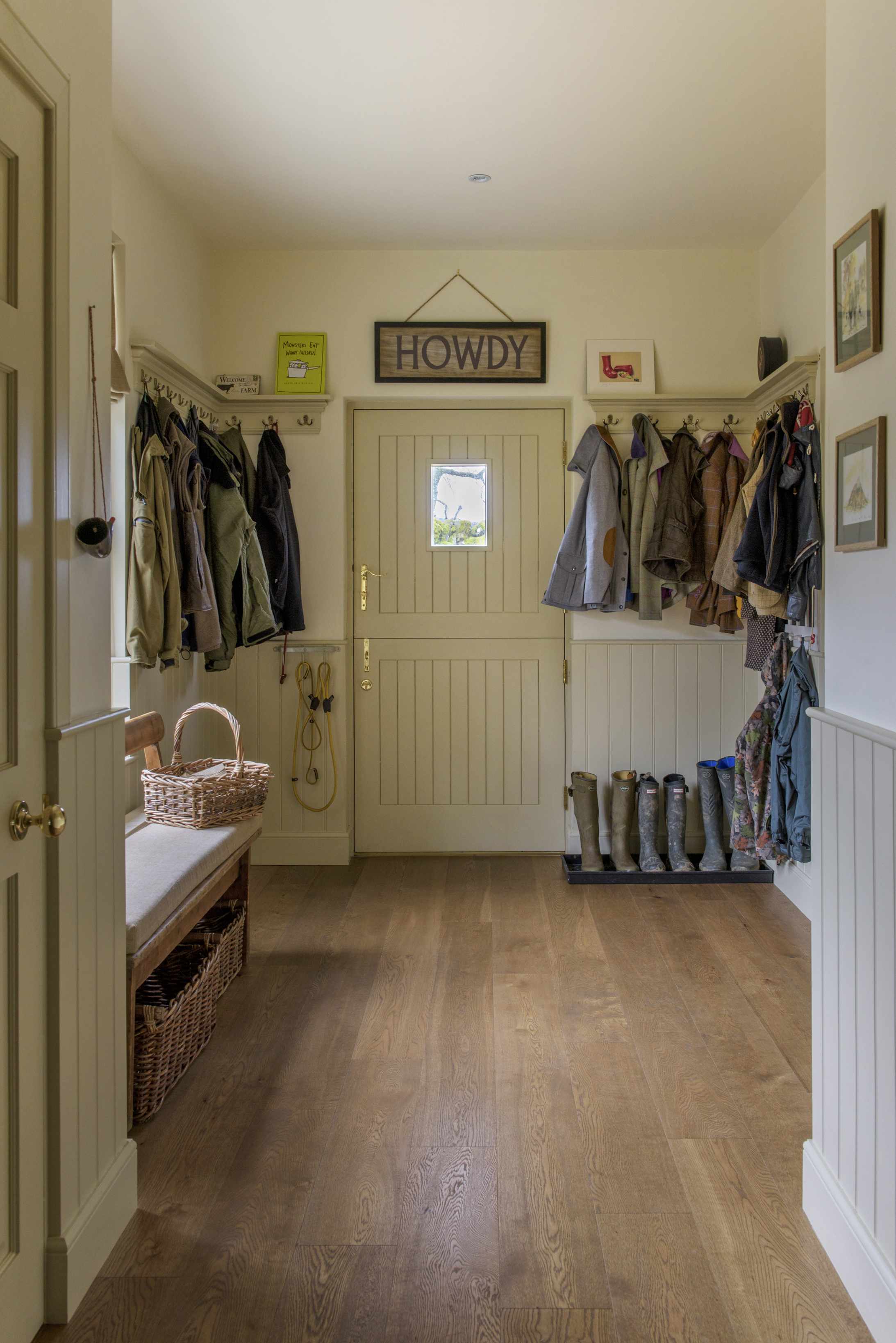 boot room with coat pegs and barn door