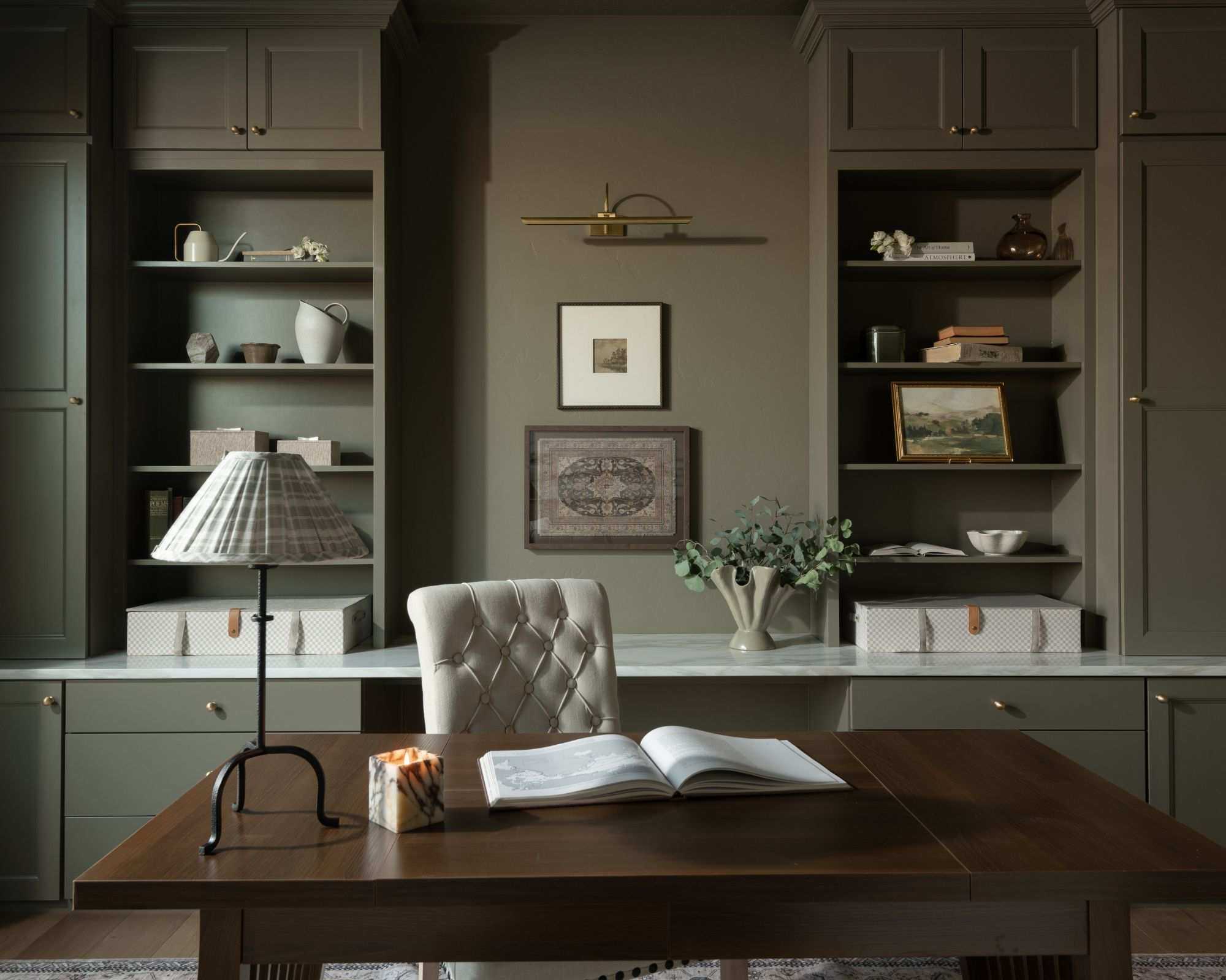home office with gray-green color drenched walls and built-in shelving